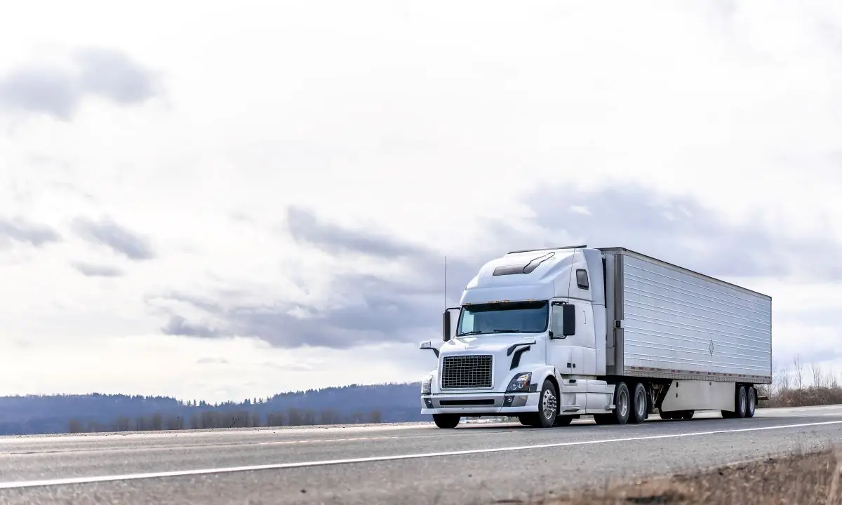 Pacific Science Lab Moving Services page - Image of white semi truck driving on highway